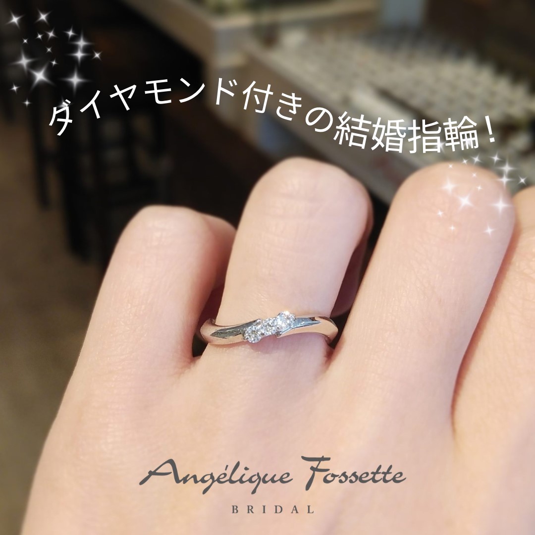 ダイヤモンド付きの結婚指輪を着けた手元